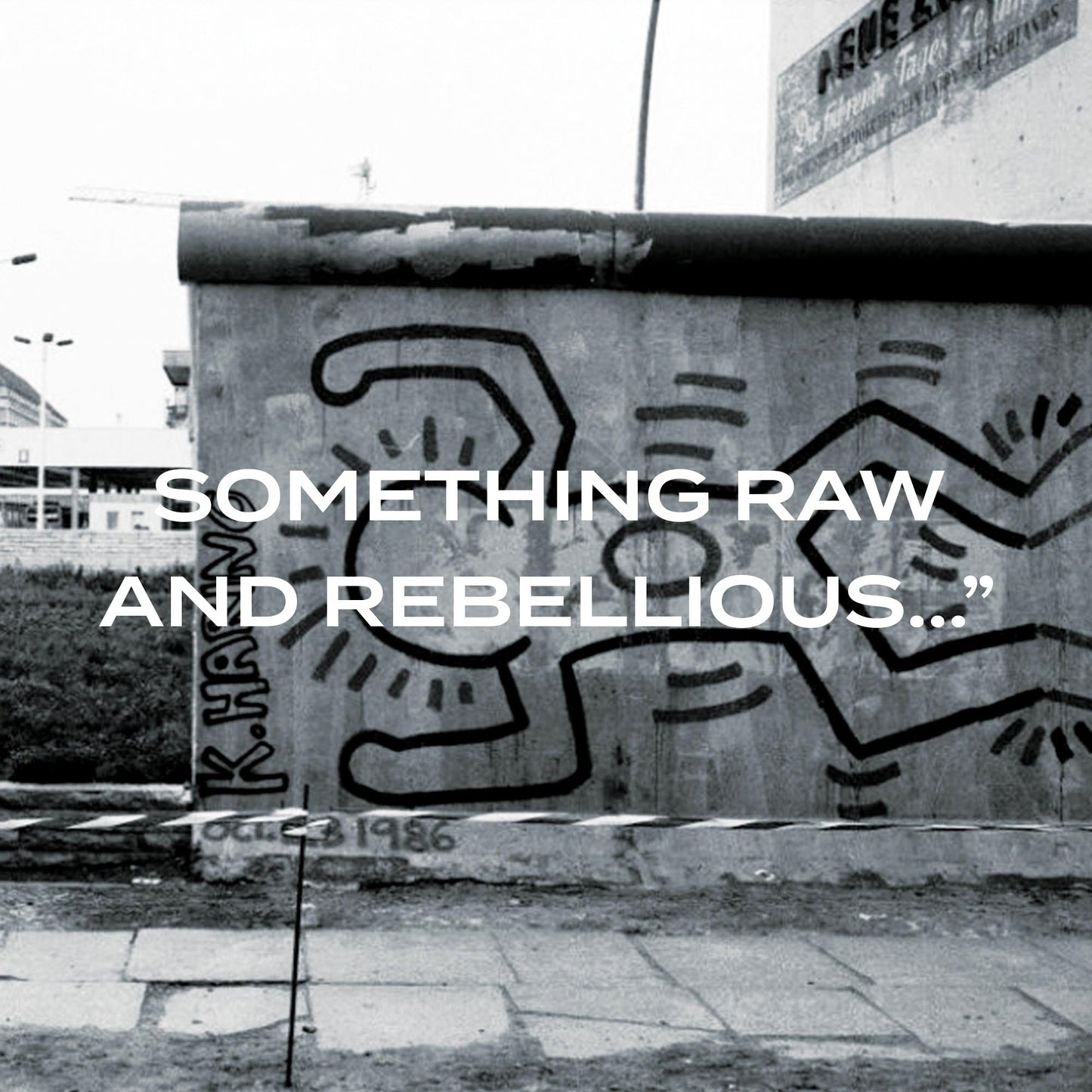 Black and white mural on a wall with abstract designs and text overlay.